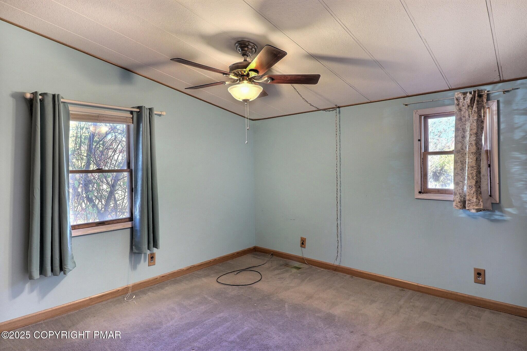 120 Upper Green Hill Road Kunkletown, PA 18058 - Photo 12 of 19 an empty room with windows and fan