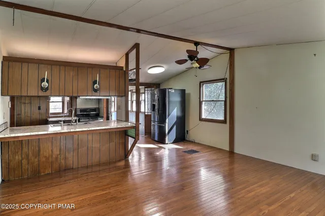 a large kitchen with a table and chairs in it