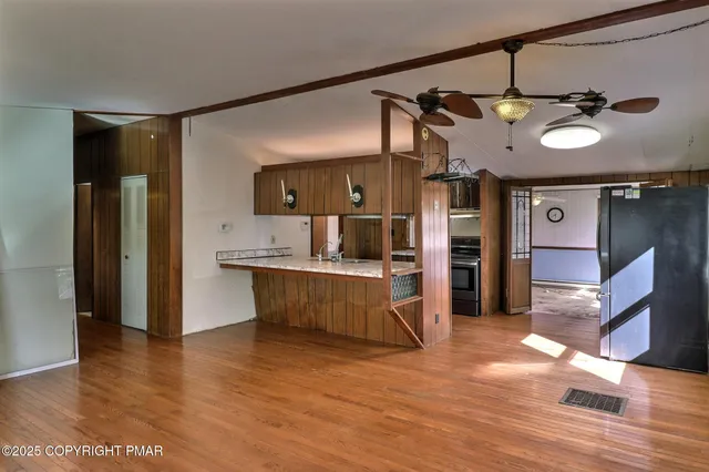 a kitchen with stainless steel appliances granite countertop a refrigerator and a stove top oven