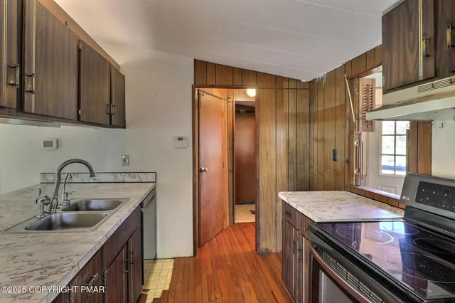 a kitchen with a sink stove and cabinets