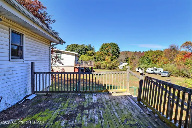 a view of a roof deck with wooden fence