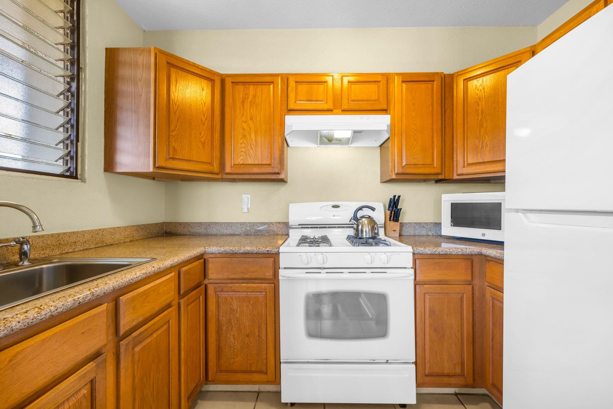 2531 South Kihei Road, Unit C620 Kihei, HI 96753 - Photo 21 of 38 a kitchen with a sink stove and cabinets
