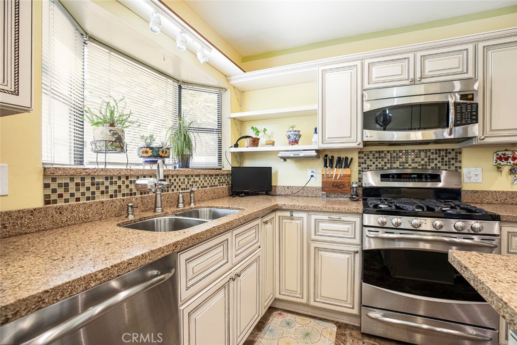 1130 Park Avenue Glendale, CA 91205 - Photo 33 of 75 a kitchen with stainless steel appliances granite countertop a sink and a stove
