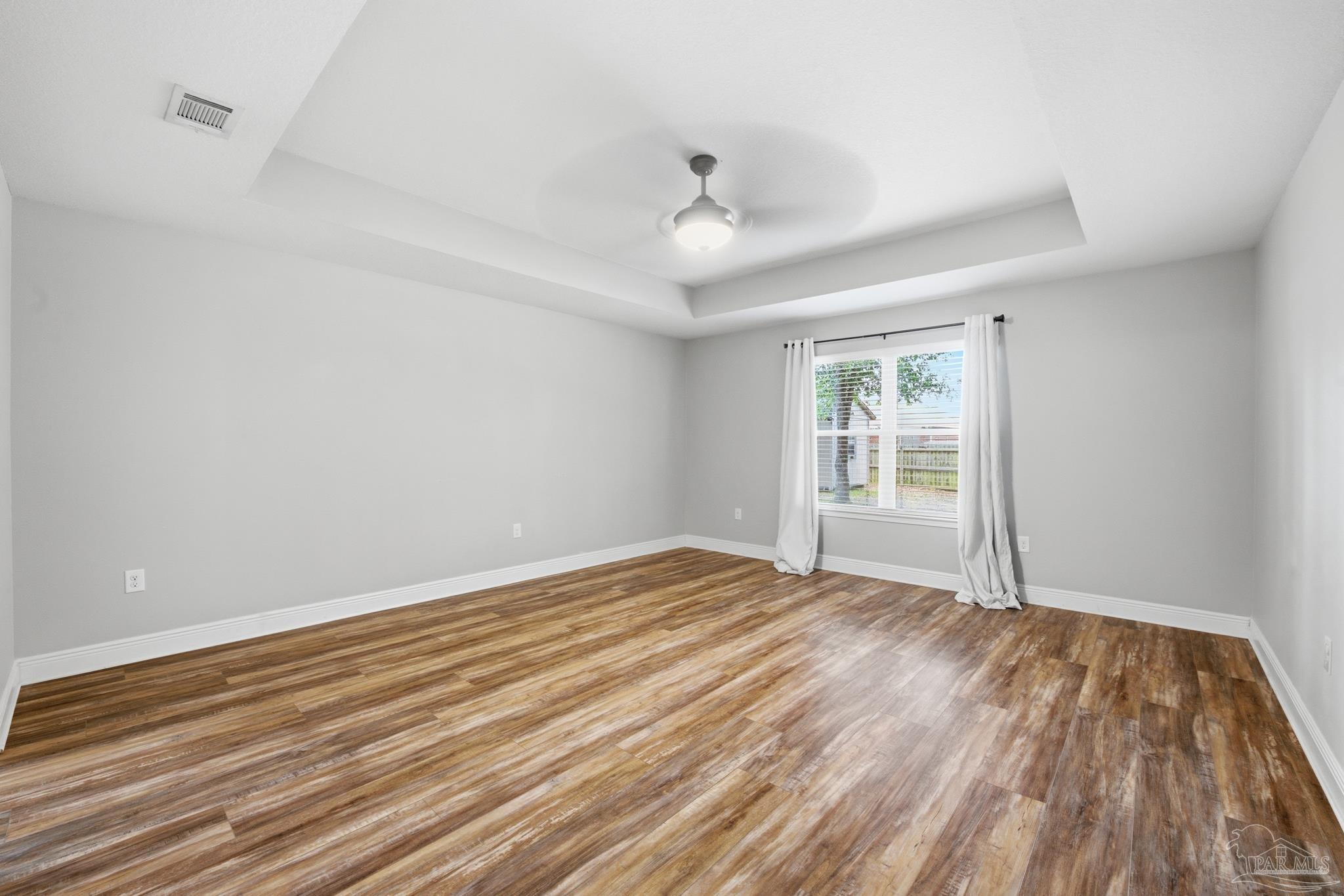 5661 Cane Syrup Circle Pace, FL 32571 - Photo 9 of 20 wooden floor in an empty room with a window