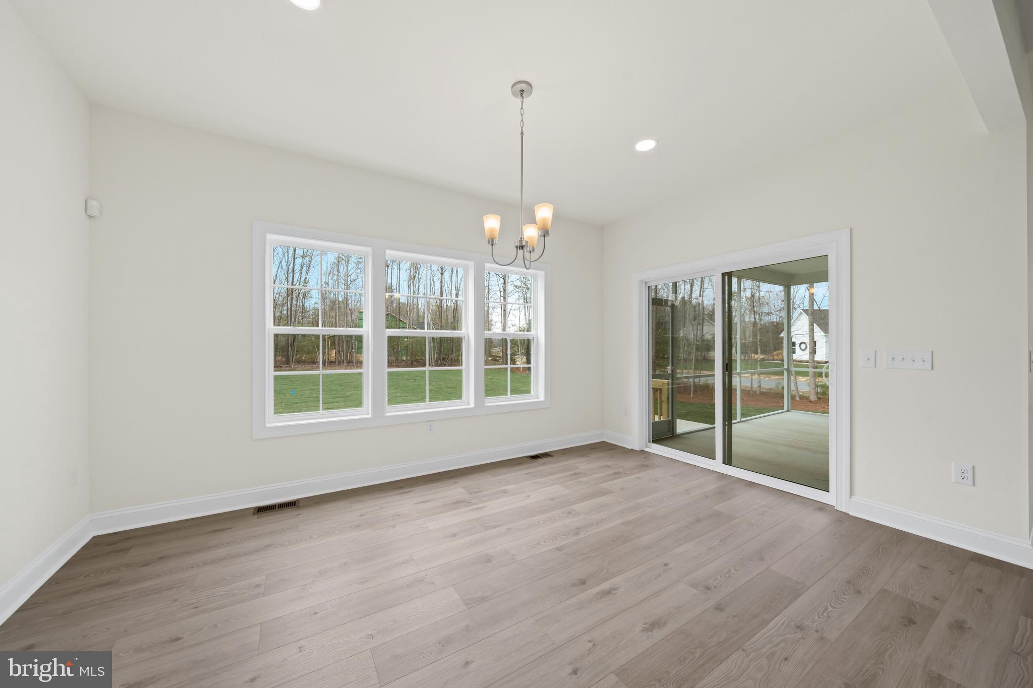 22598 Hummingbird Road, Unit 18 Ellendale, DE 19941 - Photo 11 of 15 a view of an empty room with wooden floor and a window