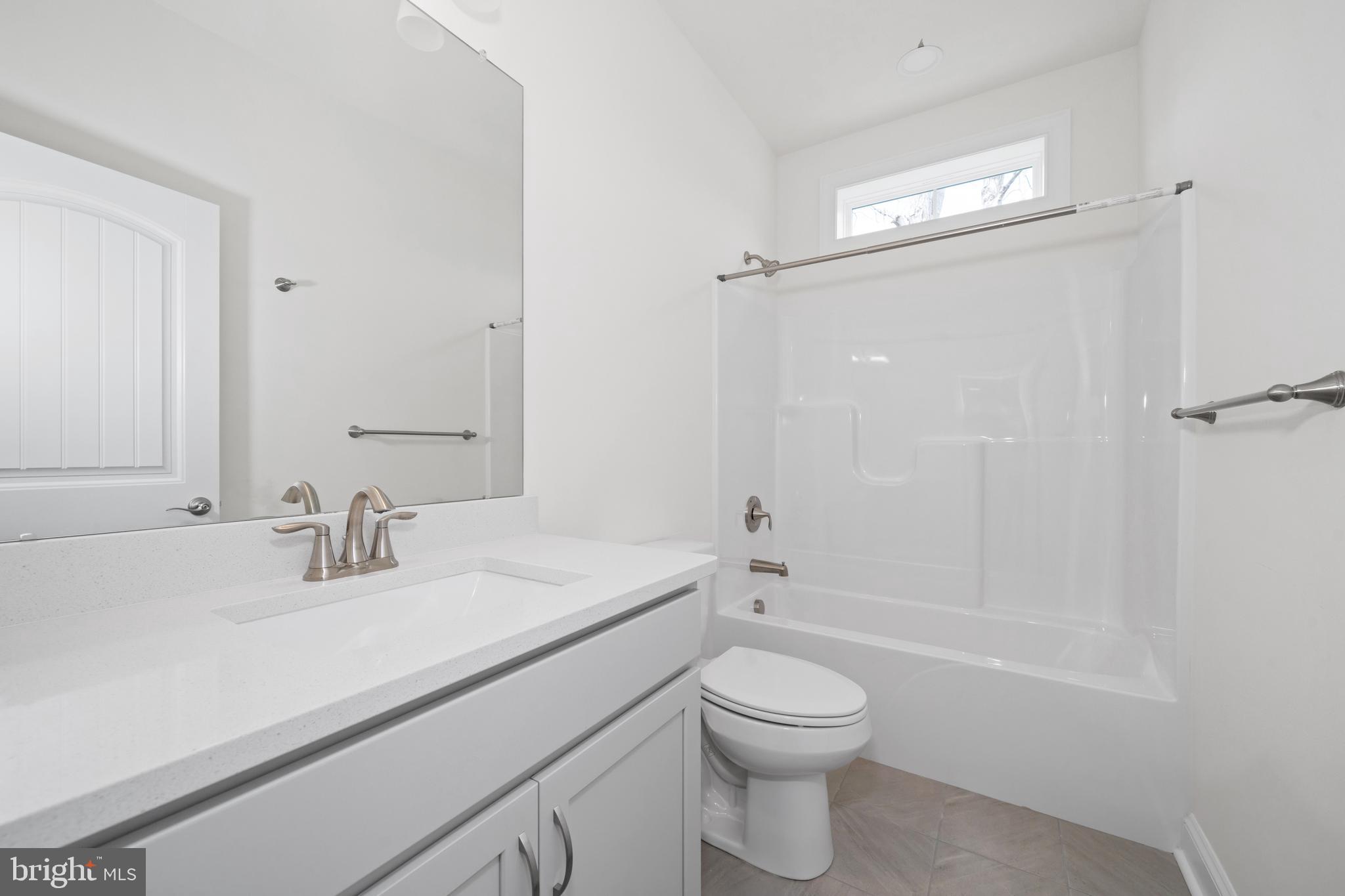22598 Hummingbird Road, Unit 18 Ellendale, DE 19941 - Photo 13 of 15 a bathroom with a sink a toilet and shower