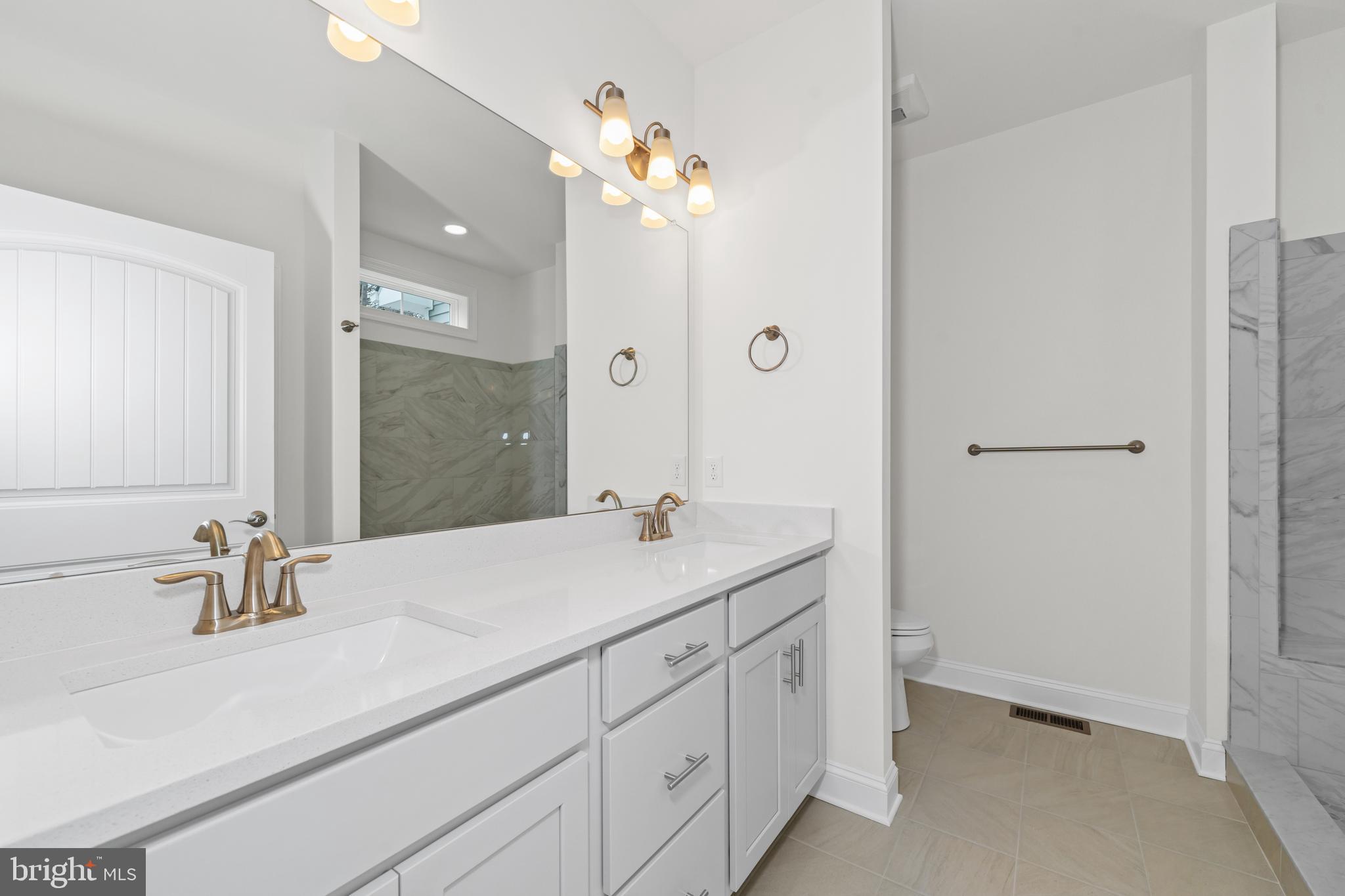 22598 Hummingbird Road, Unit 18 Ellendale, DE 19941 - Photo 14 of 15 a bathroom with a sink and a mirror