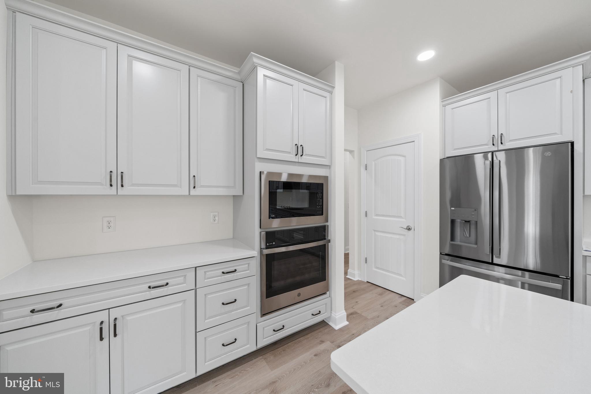 22598 Hummingbird Road, Unit 18 Ellendale, DE 19941 - Photo 6 of 15 a kitchen with stainless steel appliances a refrigerator and cabinets