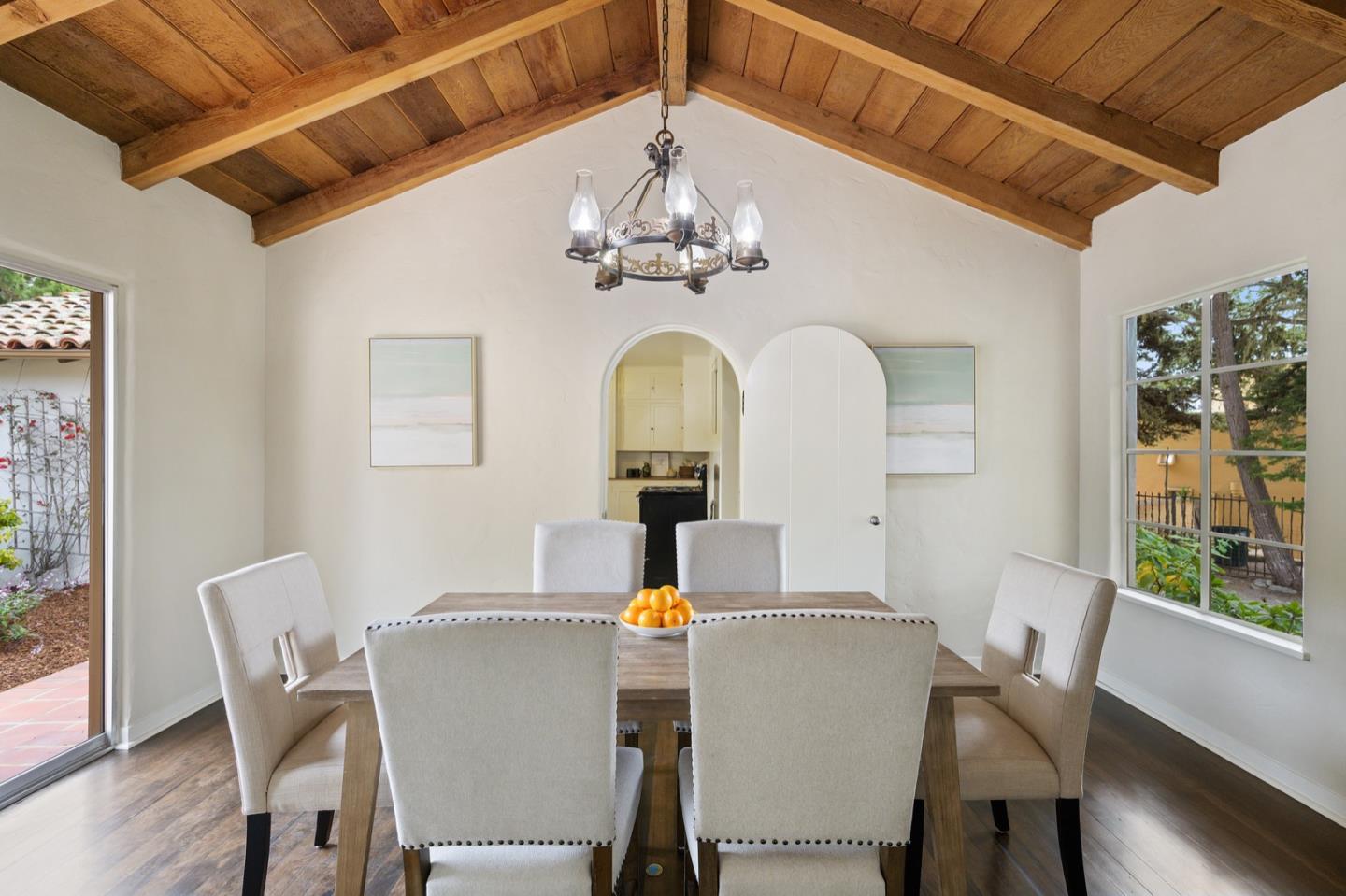 3080 Bird Rock Road Pebble Beach, CA 93953 - Photo 16 of 46 a dining room with furniture a chandelier and wooden floor