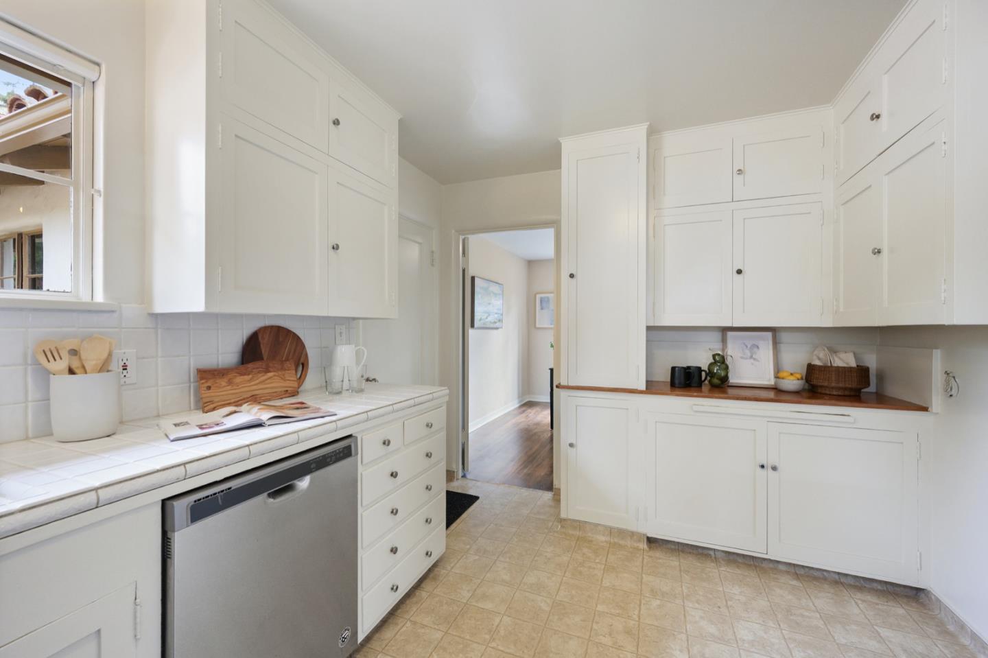 3080 Bird Rock Road Pebble Beach, CA 93953 - Photo 20 of 46 a kitchen with white cabinets and appliances