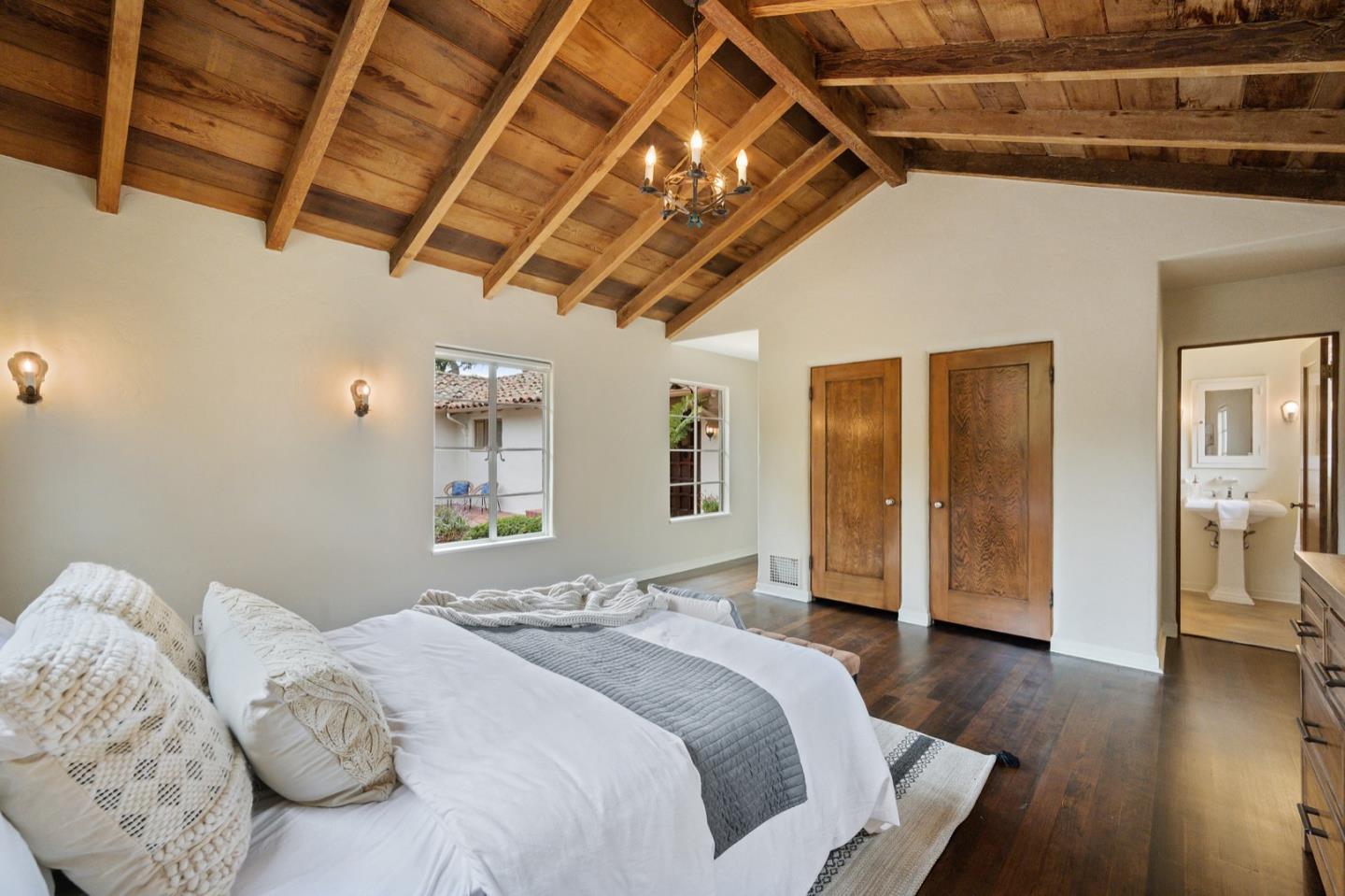 3080 Bird Rock Road Pebble Beach, CA 93953 - Photo 24 of 46 a spacious bedroom with a bed and wooden floor