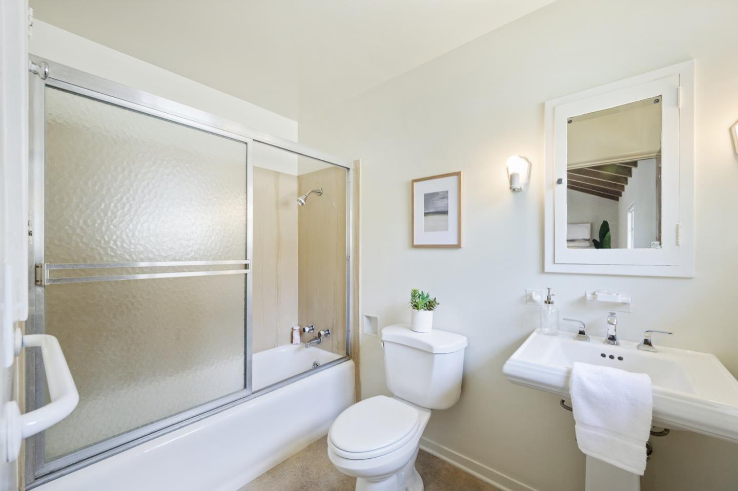 3080 Bird Rock Road Pebble Beach, CA 93953 - Photo 25 of 46 a white toilet sitting next to a bathroom sink