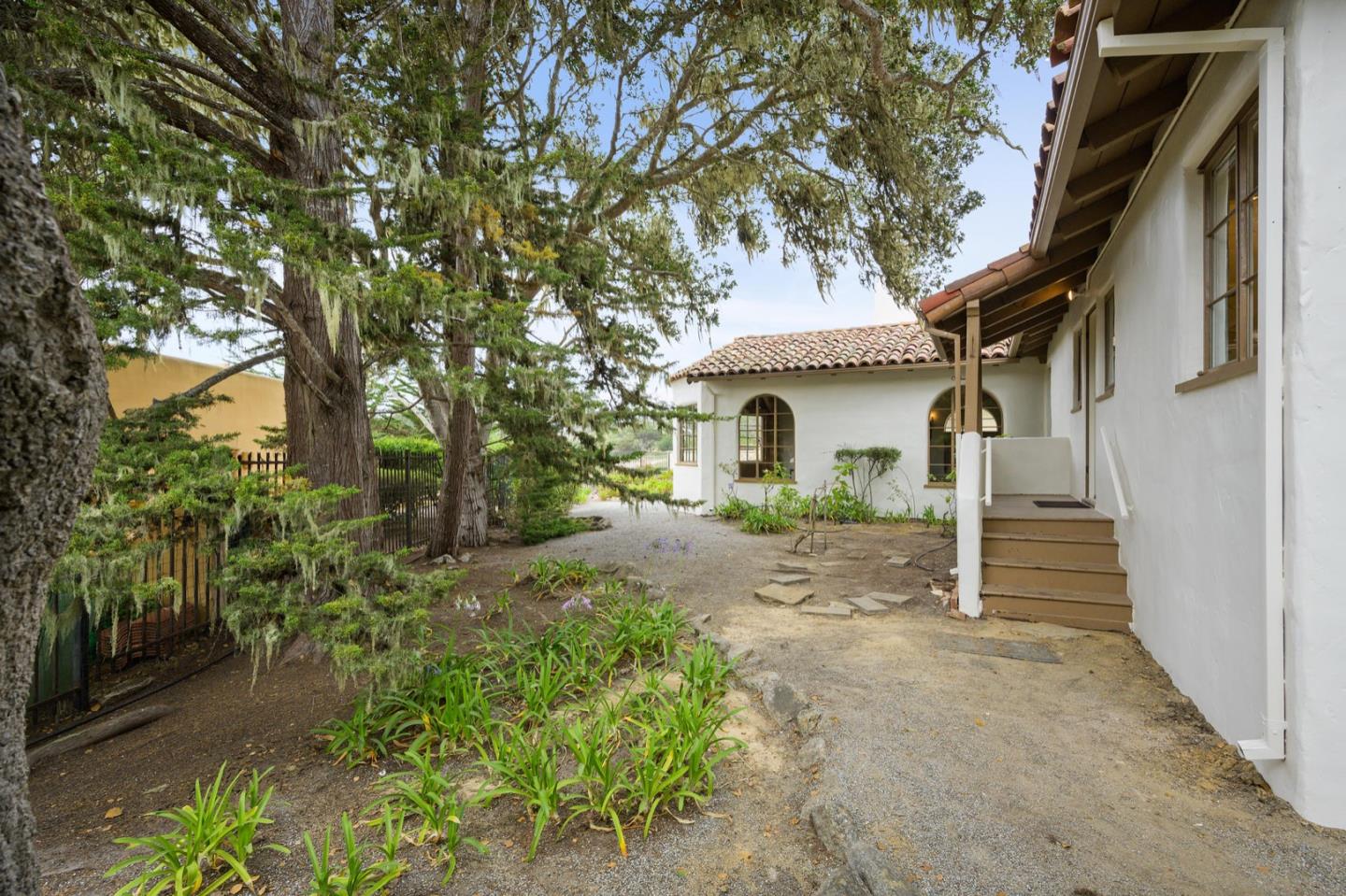 3080 Bird Rock Road Pebble Beach, CA 93953 - Photo 32 of 46 a front view of a house with a yard