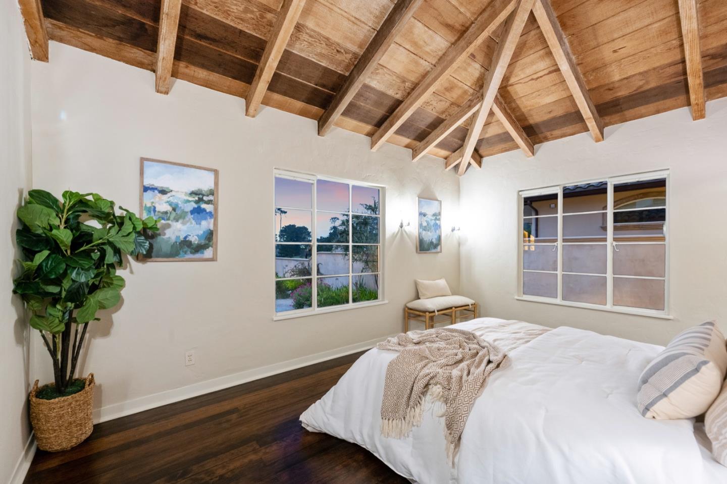 3080 Bird Rock Road Pebble Beach, CA 93953 - Photo 38 of 46 a bedroom with a large bed and a potted plant