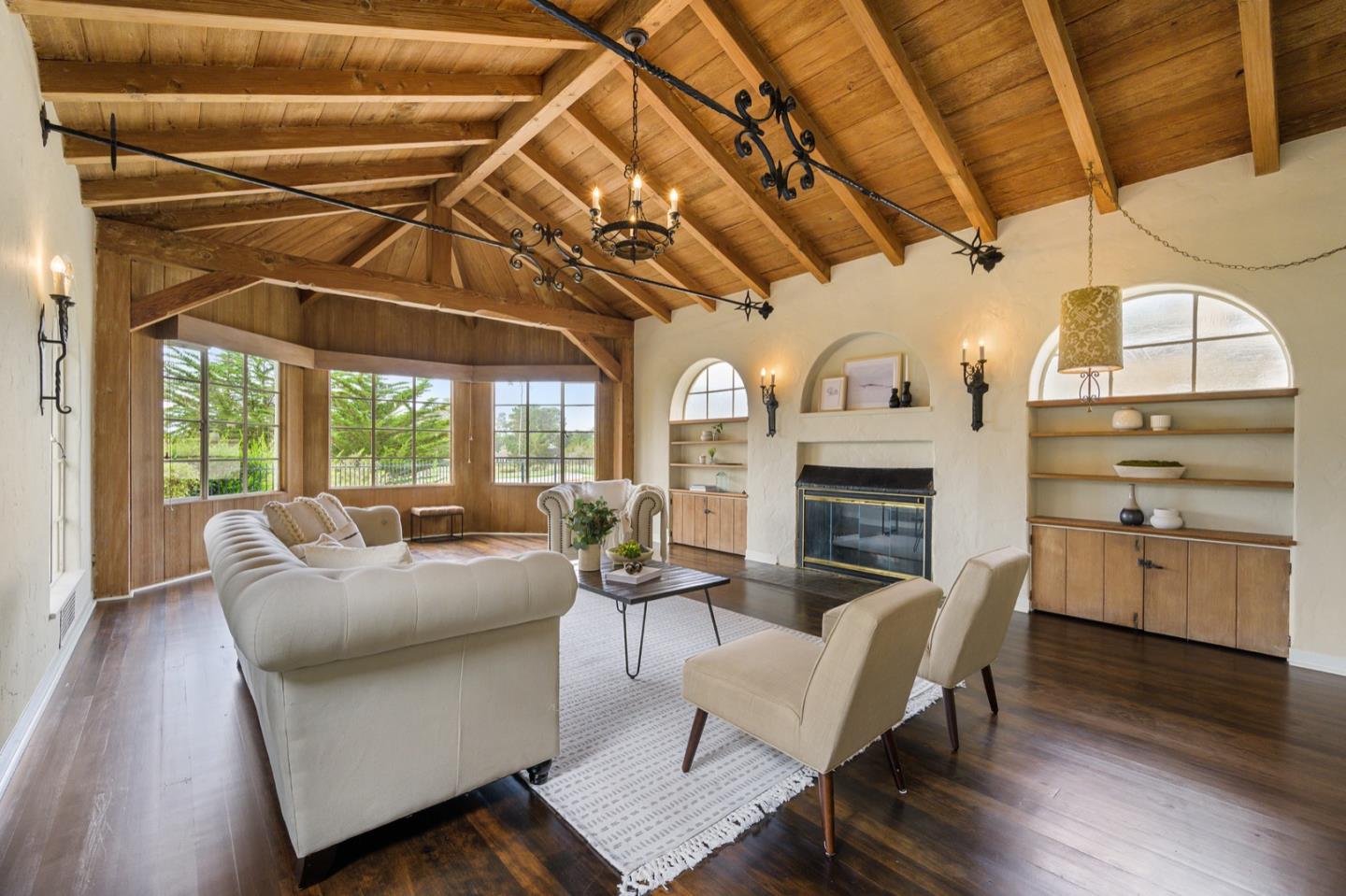 3080 Bird Rock Road Pebble Beach, CA 93953 - Photo 8 of 46 a living room with furniture a fireplace and wooden floor