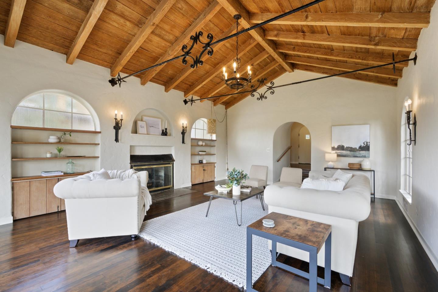 3080 Bird Rock Road Pebble Beach, CA 93953 - Photo 10 of 46 a living room with furniture a fireplace and a table with wooden floor