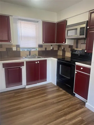 a kitchen with a refrigerator and a sink