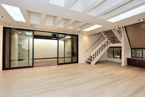 a view of kitchen with stainless steel appliances cabinets and window