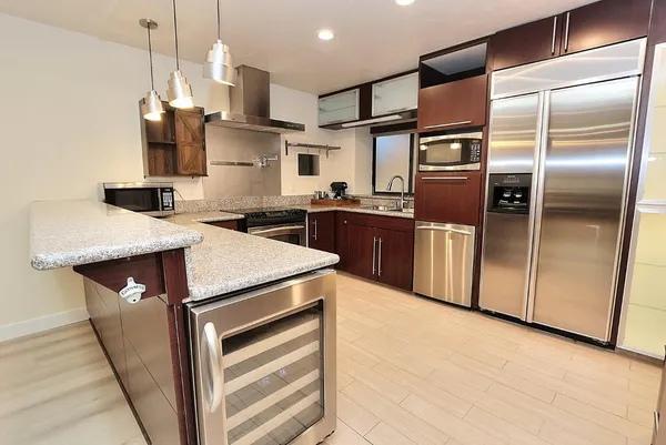 a view of an empty room with wooden floor and closet