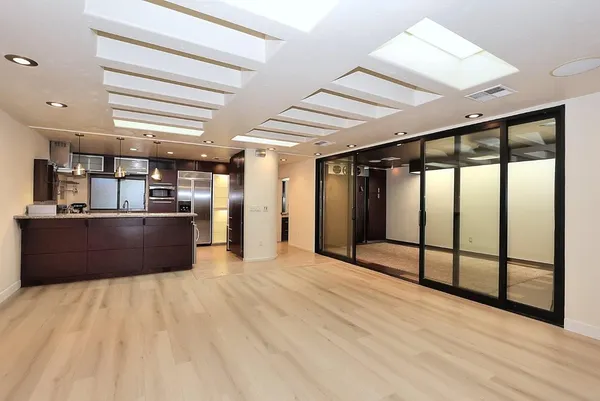 a kitchen with a refrigerator and a sink