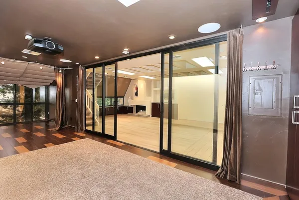 a view of an empty room with wooden floor and closet
