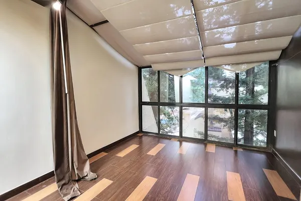 a view of a back yard with a wooden fence
