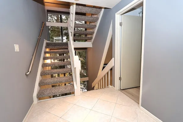 a bathroom with a granite countertop sink a toilet and shower