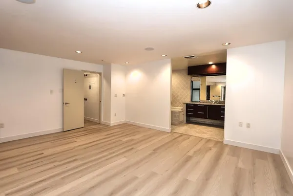 a kitchen with kitchen island granite countertop a sink stainless steel appliances and cabinets
