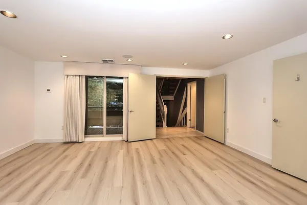 a bathroom with a granite countertop sink a toilet and shower