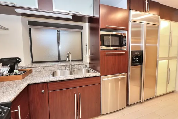 a kitchen with stainless steel appliances granite countertop a sink stove and refrigerator