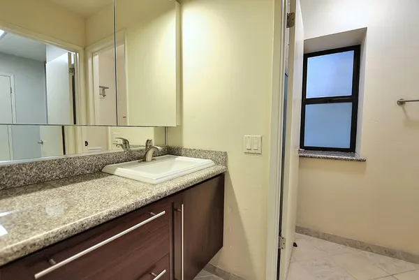a view of balcony with furniture and large window
