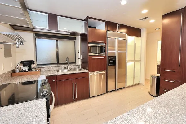 a view of walk in closet and wooden floor