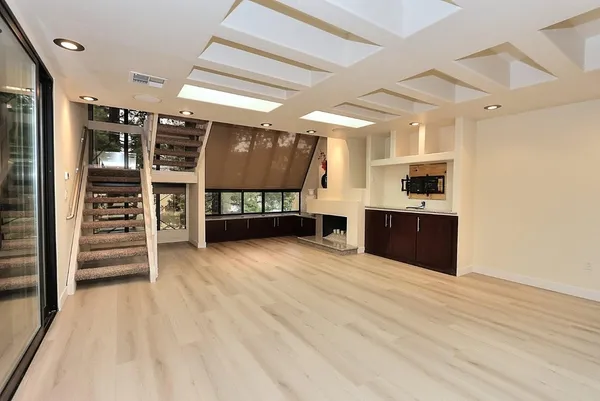a living room with a large window and a flat screen tv