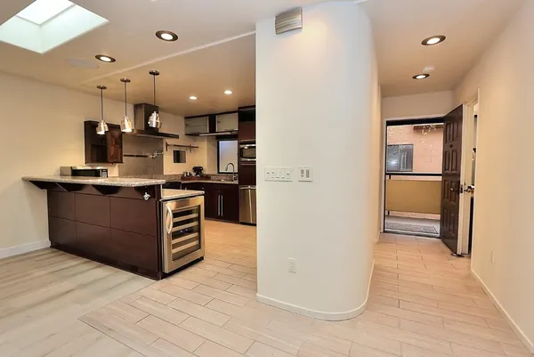 a kitchen with sink and refrigerator