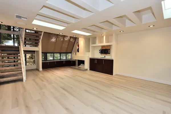 a kitchen with stainless steel appliances granite countertop a stove a sink and a refrigerator