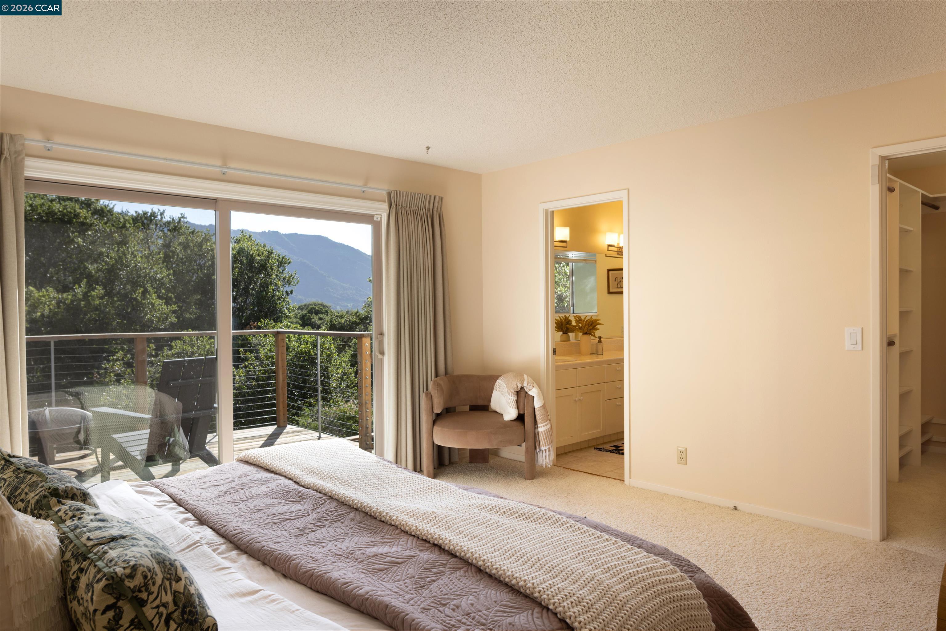 12 Marquard Road Carmel Valley, CA 93924 - Photo 22 of 36 a bedroom with a bed and a large window