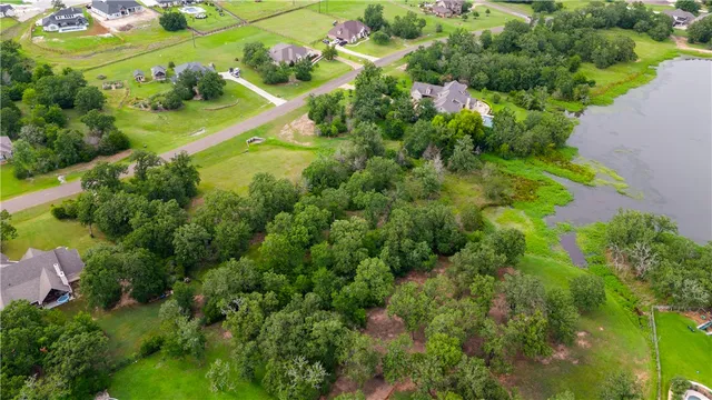 an aerial view of residential houses with outdoor space and street view