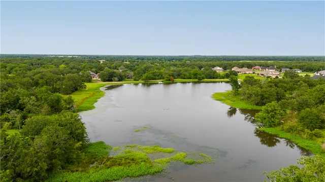 an aerial view of a houses with a lake view