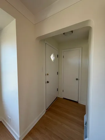 a view of room with wooden floor