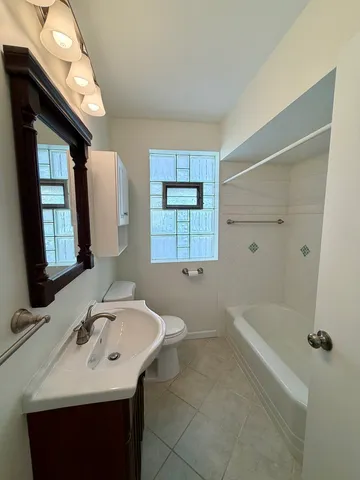 a bathroom with a bath tub with a shower