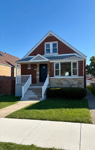 a front view of a house with a yard table and chairs
