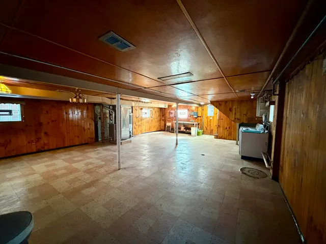 a view of backyard with wooden fence