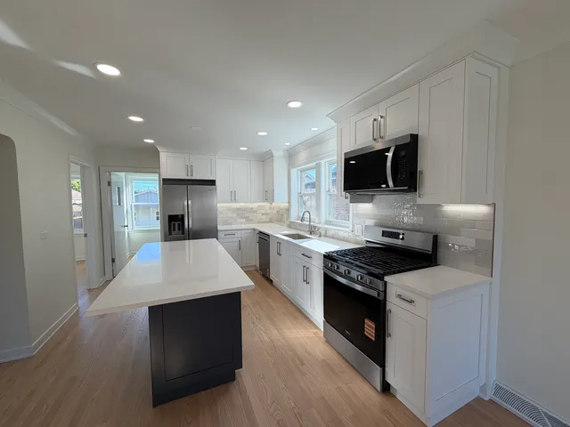 a kitchen with a sink stove and refrigerator