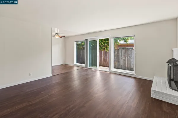 an empty room with wooden floor and a window