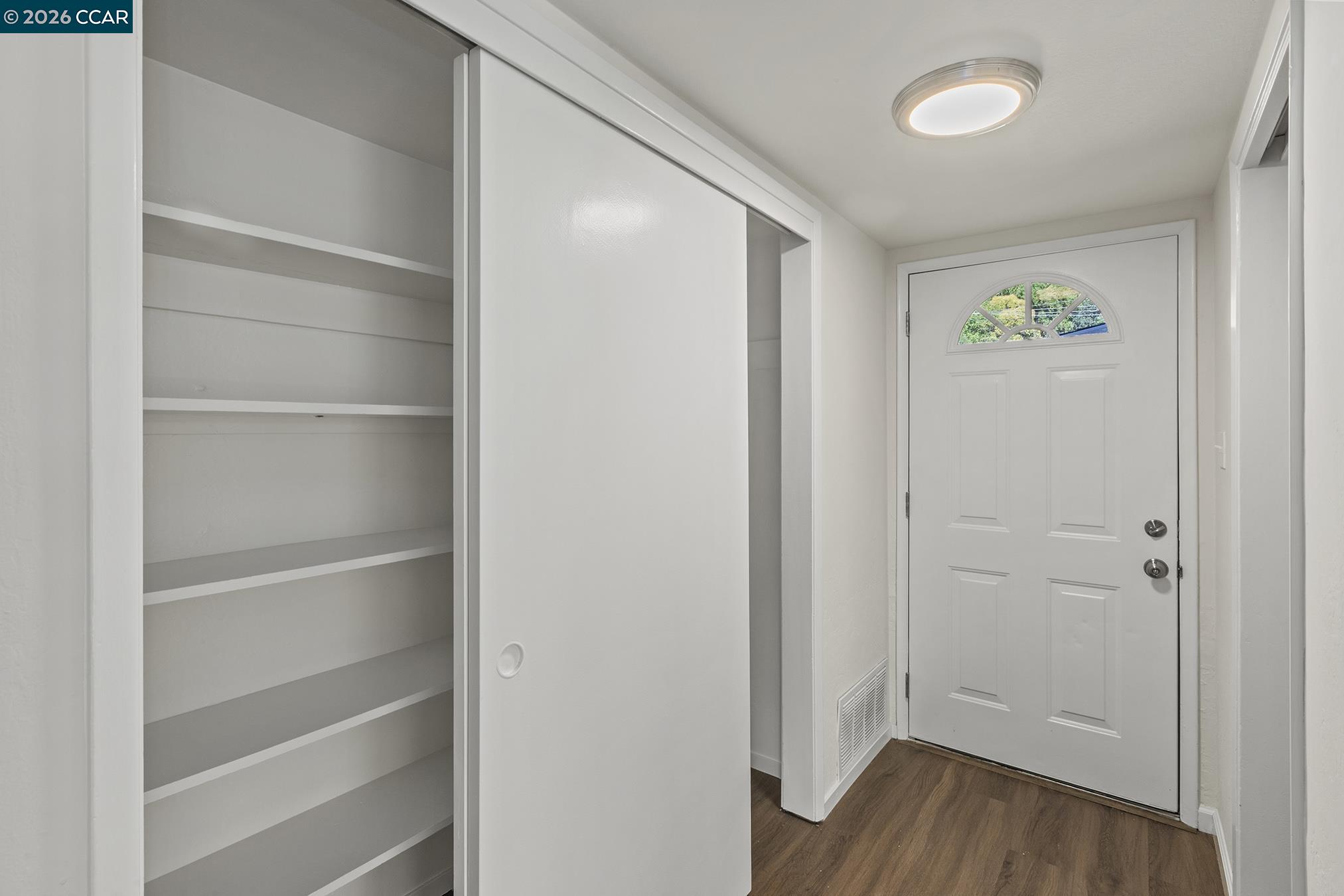 29 Leafwood Circle San Rafael, CA 94901 - Photo 4 of 34 a view of an empty room with closet and wooden floor