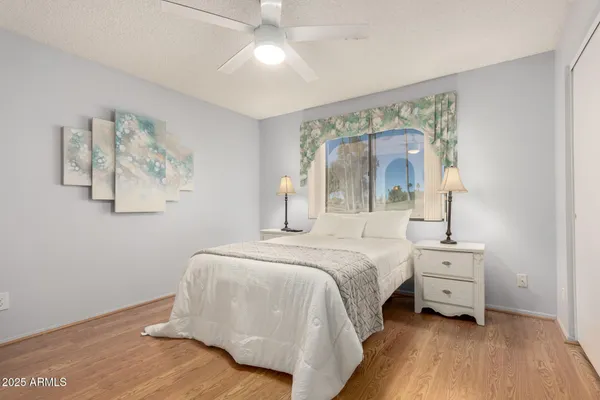 a bedroom with a large bed and a chandelier
