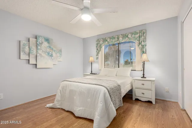 a bedroom with a large bed and a chandelier