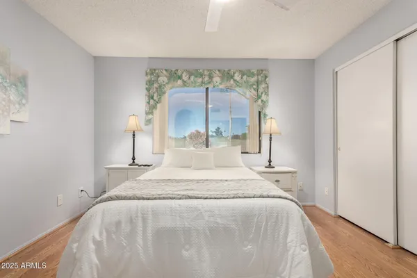 a large bed sitting in a bedroom next to a window