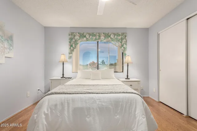 a large bed sitting in a bedroom next to a window