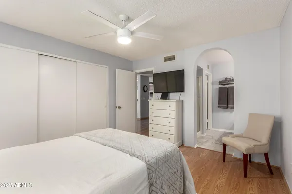 a bedroom with a bed and a chair